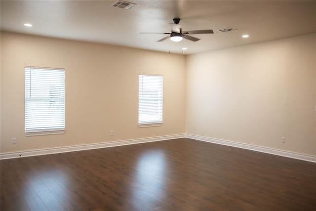 unfurnished room featuring dark wood-type flooring and ceiling fan