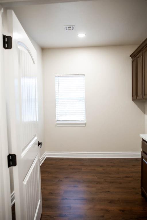 unfurnished dining area featuring dark hardwood / wood-style floors