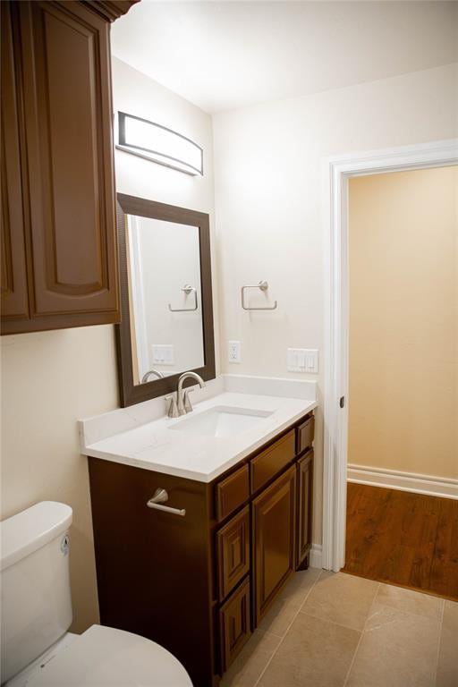 bathroom featuring vanity and toilet