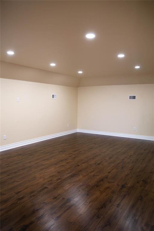 unfurnished room with dark wood-type flooring