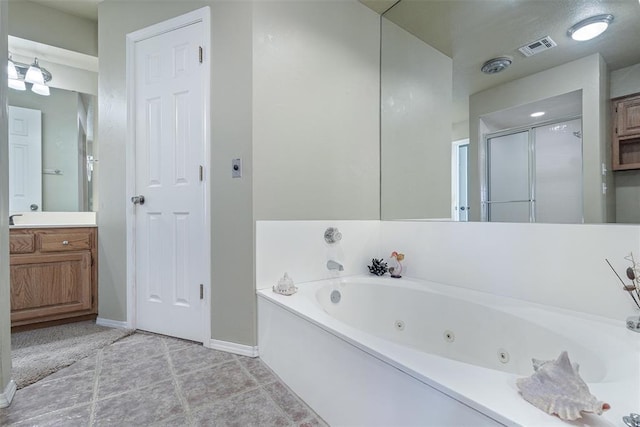 bathroom with vanity, tile patterned floors, and plus walk in shower