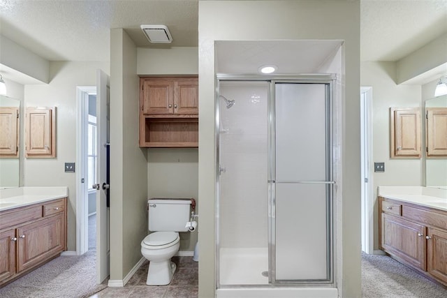 bathroom featuring an enclosed shower, vanity, and toilet