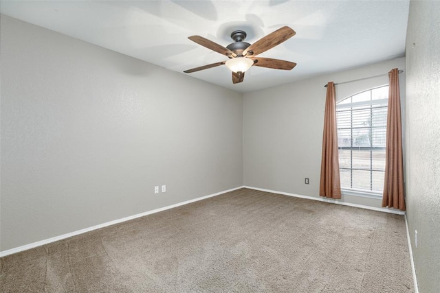 empty room with carpet and ceiling fan