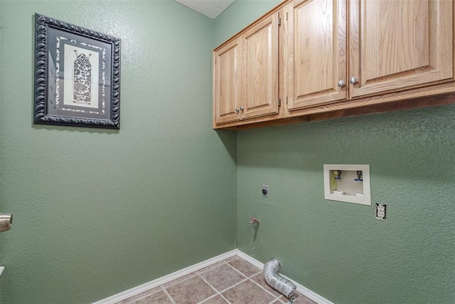 clothes washing area featuring gas dryer hookup, electric dryer hookup, cabinets, washer hookup, and tile patterned floors