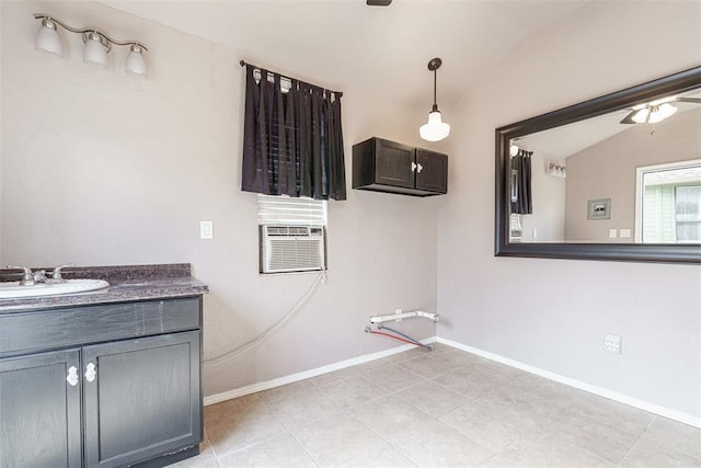 bathroom with vanity, lofted ceiling, and tile patterned floors