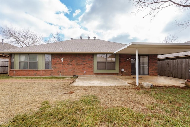 rear view of property featuring a patio and a lawn