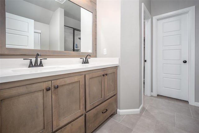 bathroom featuring vanity, a shower, and tile patterned floors