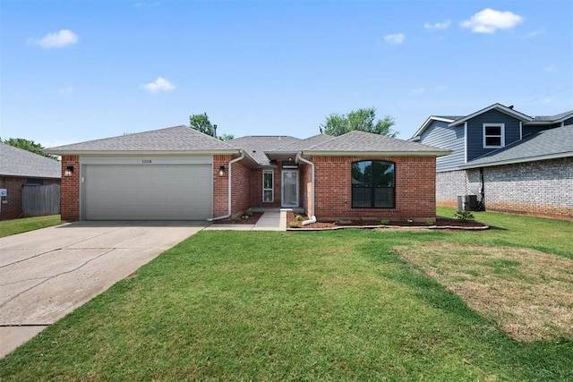 view of front of home featuring a garage, central air condition unit, and a front lawn