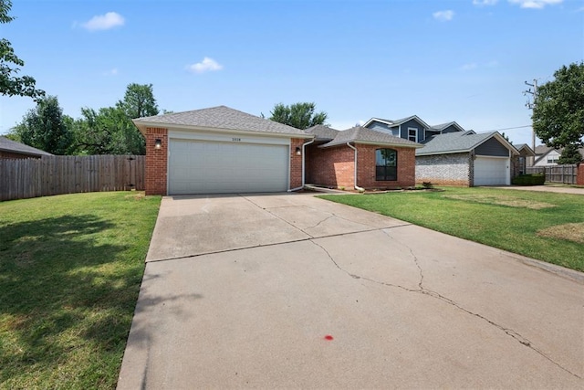 single story home featuring a garage and a front lawn