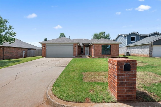 view of front of property with a garage and a front lawn