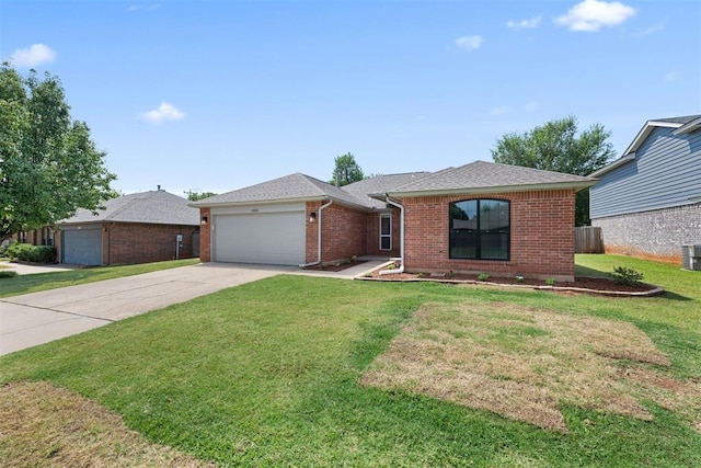 ranch-style home with cooling unit, a garage, and a front yard