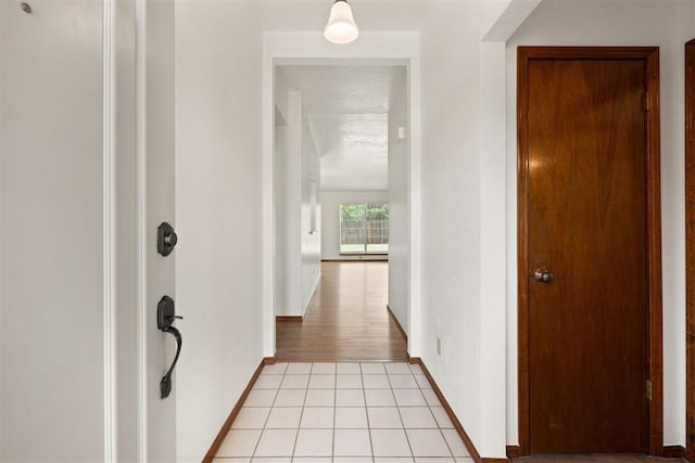 hallway with light tile patterned floors