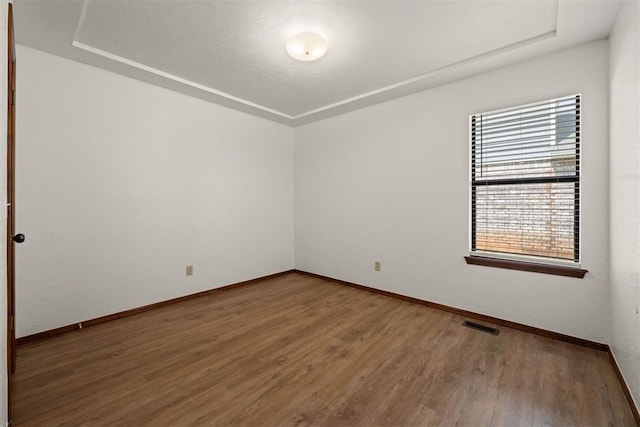 unfurnished room featuring hardwood / wood-style flooring