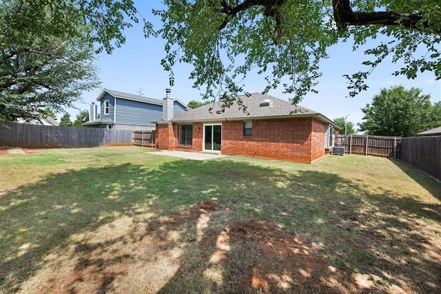 rear view of property featuring a patio and a lawn