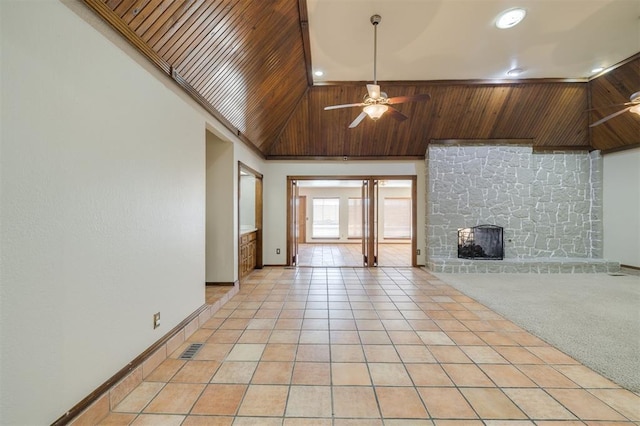 unfurnished living room with light tile patterned flooring, a stone fireplace, high vaulted ceiling, and ceiling fan