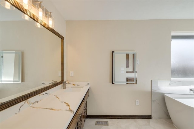 bathroom with vanity and a bath