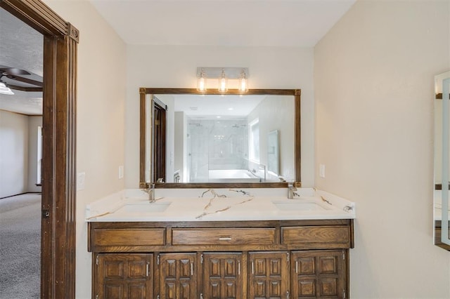 bathroom with a shower with door and vanity