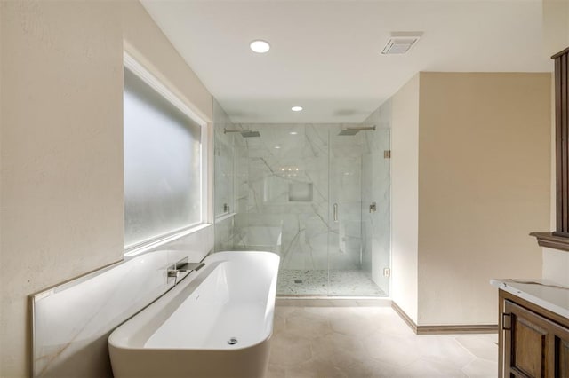 bathroom featuring vanity and shower with separate bathtub