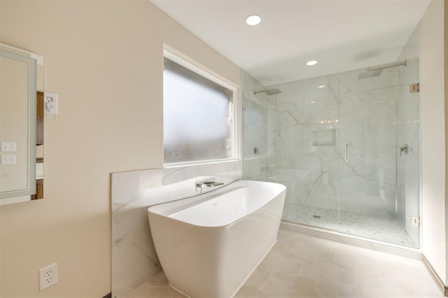 bathroom featuring tile patterned flooring and shower with separate bathtub