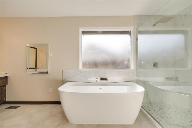 bathroom featuring vanity, tile patterned floors, and shower with separate bathtub