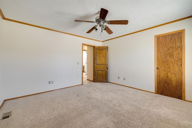 spare room with ornamental molding, light colored carpet, and ceiling fan