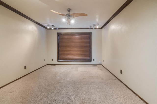 spare room featuring crown molding, light colored carpet, and ceiling fan