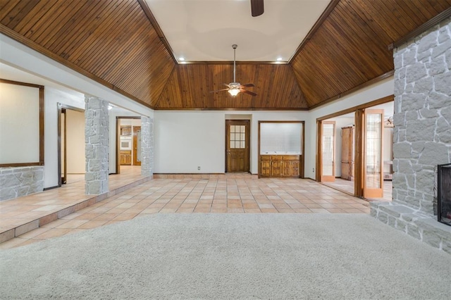 unfurnished living room with light carpet, wood ceiling, a stone fireplace, and high vaulted ceiling