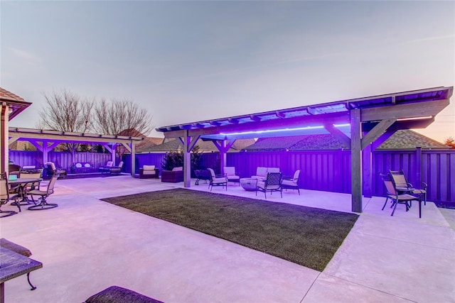 view of patio with an outdoor living space with a fire pit and a fenced backyard