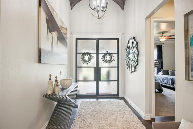 entrance foyer with baseboards and a chandelier