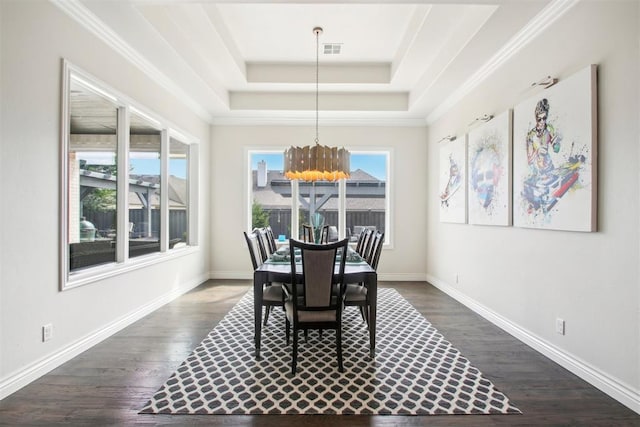 dining space featuring visible vents, a raised ceiling, baseboards, and dark wood finished floors