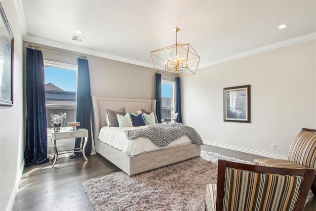 bedroom featuring baseboards, wood finished floors, and crown molding