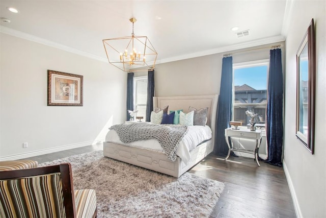 bedroom featuring wood finished floors, baseboards, visible vents, crown molding, and a notable chandelier