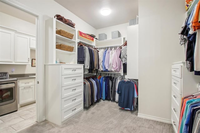 spacious closet with light carpet