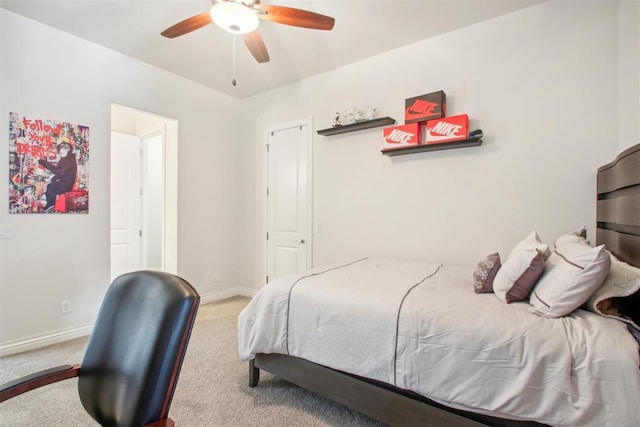 carpeted bedroom with a ceiling fan and baseboards