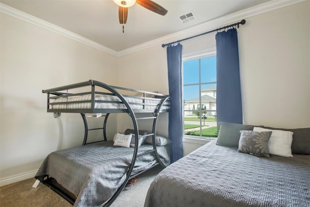 carpeted bedroom featuring crown molding, baseboards, and visible vents