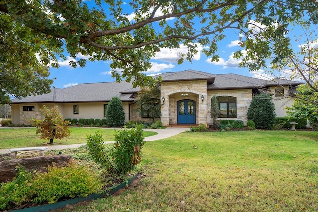 view of front of house featuring a front lawn and french doors