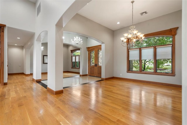 entryway featuring a notable chandelier and light hardwood / wood-style floors