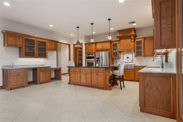 kitchen with sink, dark stone countertops, hanging light fixtures, a center island, and stainless steel fridge with ice dispenser