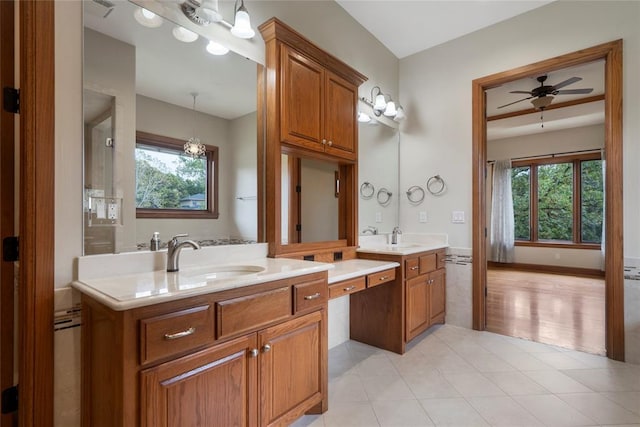 bathroom featuring tile patterned flooring, vanity, a wealth of natural light, and ceiling fan