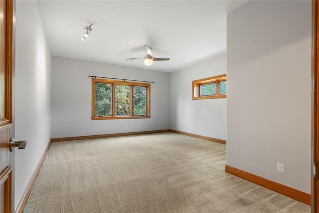 carpeted empty room featuring ceiling fan