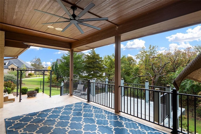 view of patio featuring ceiling fan and an outdoor fire pit