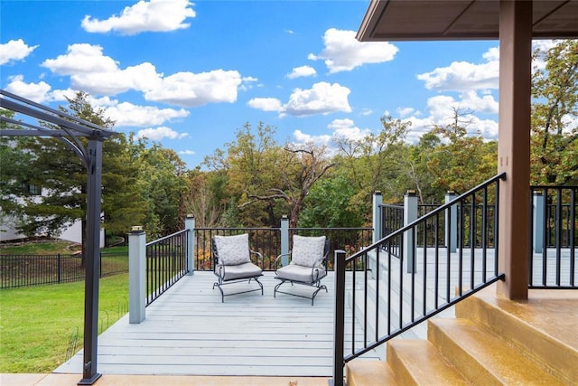 wooden deck featuring a lawn