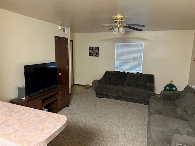 carpeted living room with ceiling fan