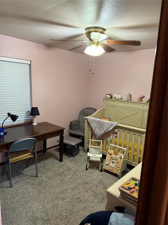 carpeted office with ceiling fan