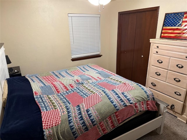 bedroom featuring dark carpet and a closet