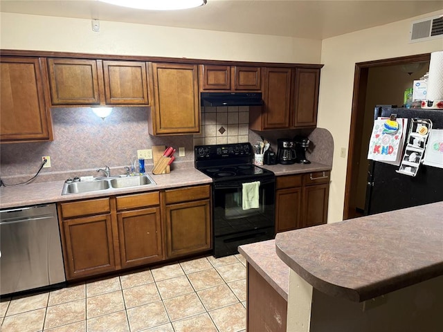 kitchen featuring tasteful backsplash, light tile patterned floors, sink, and black appliances