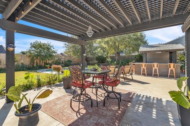 view of patio featuring exterior bar and a pergola