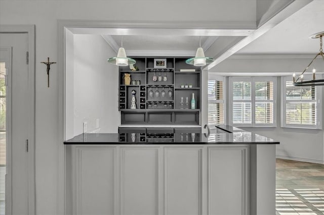 bar featuring crown molding, a chandelier, and decorative light fixtures