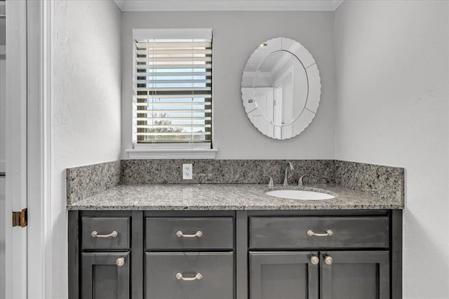 bathroom featuring ornamental molding and vanity