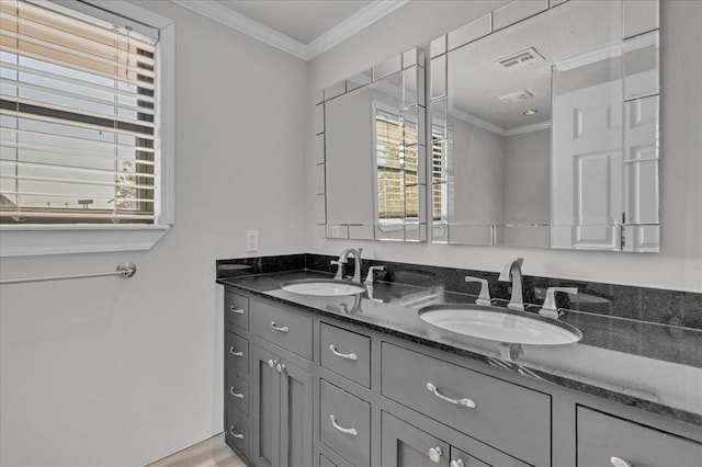 bathroom featuring ornamental molding, hardwood / wood-style floors, and vanity